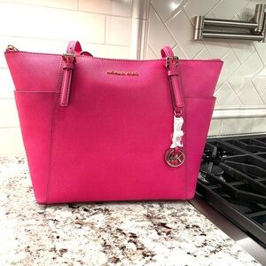 Brand new, with original protective bag, Michael Kors purse.